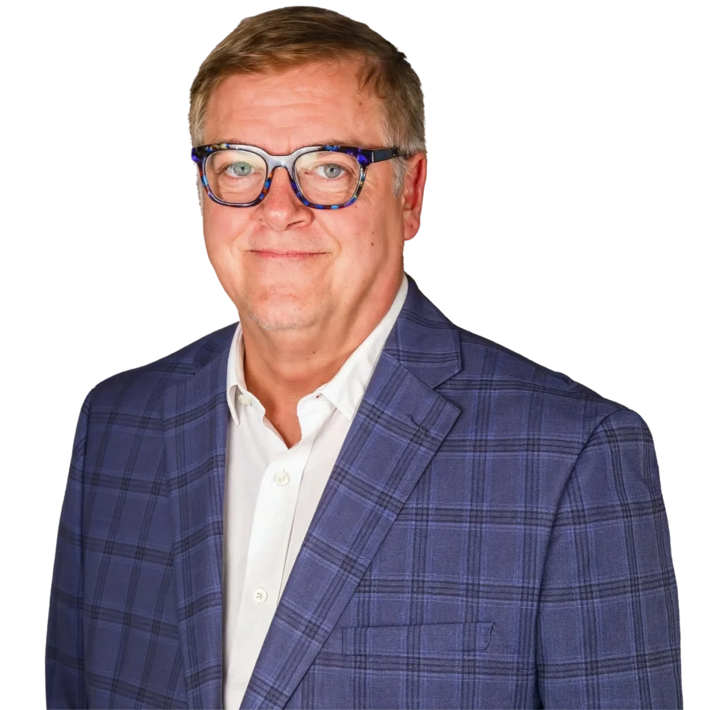 Professional headshot of a middle-aged man in a blue checkered blazer and white shirt on transparent background