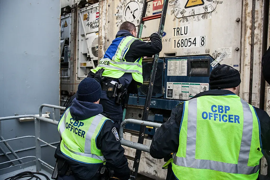 U.S. Customs and Border Protection officers inspecting imported cargo during a customs examination at a U.S. port of entry